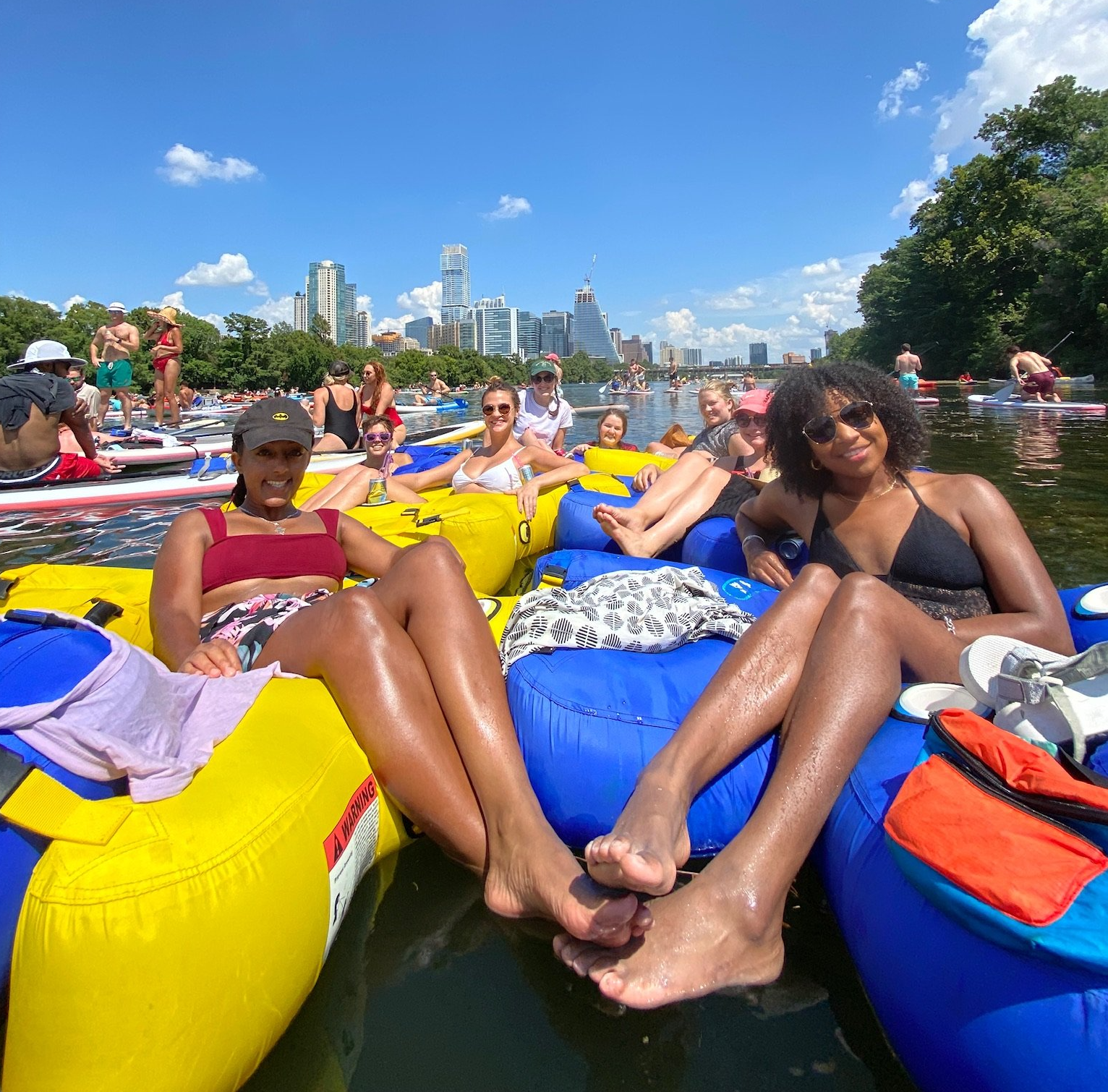 A group of people are floating on rafts in the water