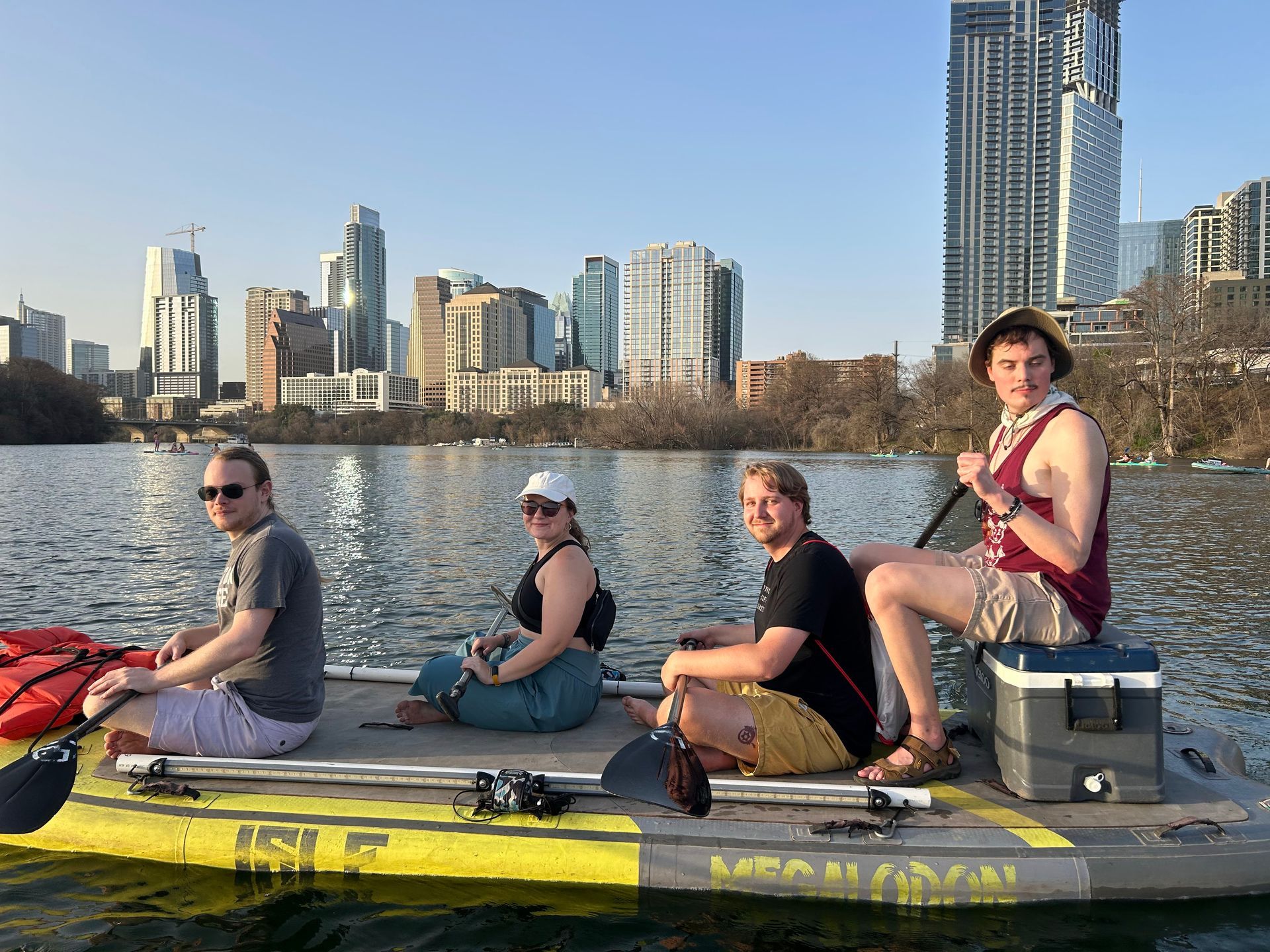 Paddleboarders wearing sun hat, quick-dry shirt, and water shoes on Lady Bird Lake