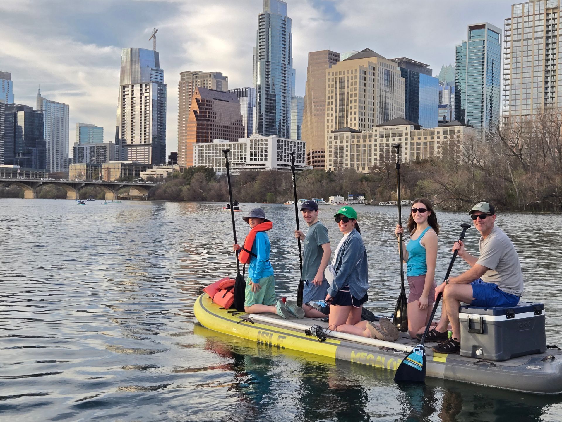 Spring paddleboarders in Austin wearing layered outfits on Lady Bird Lake