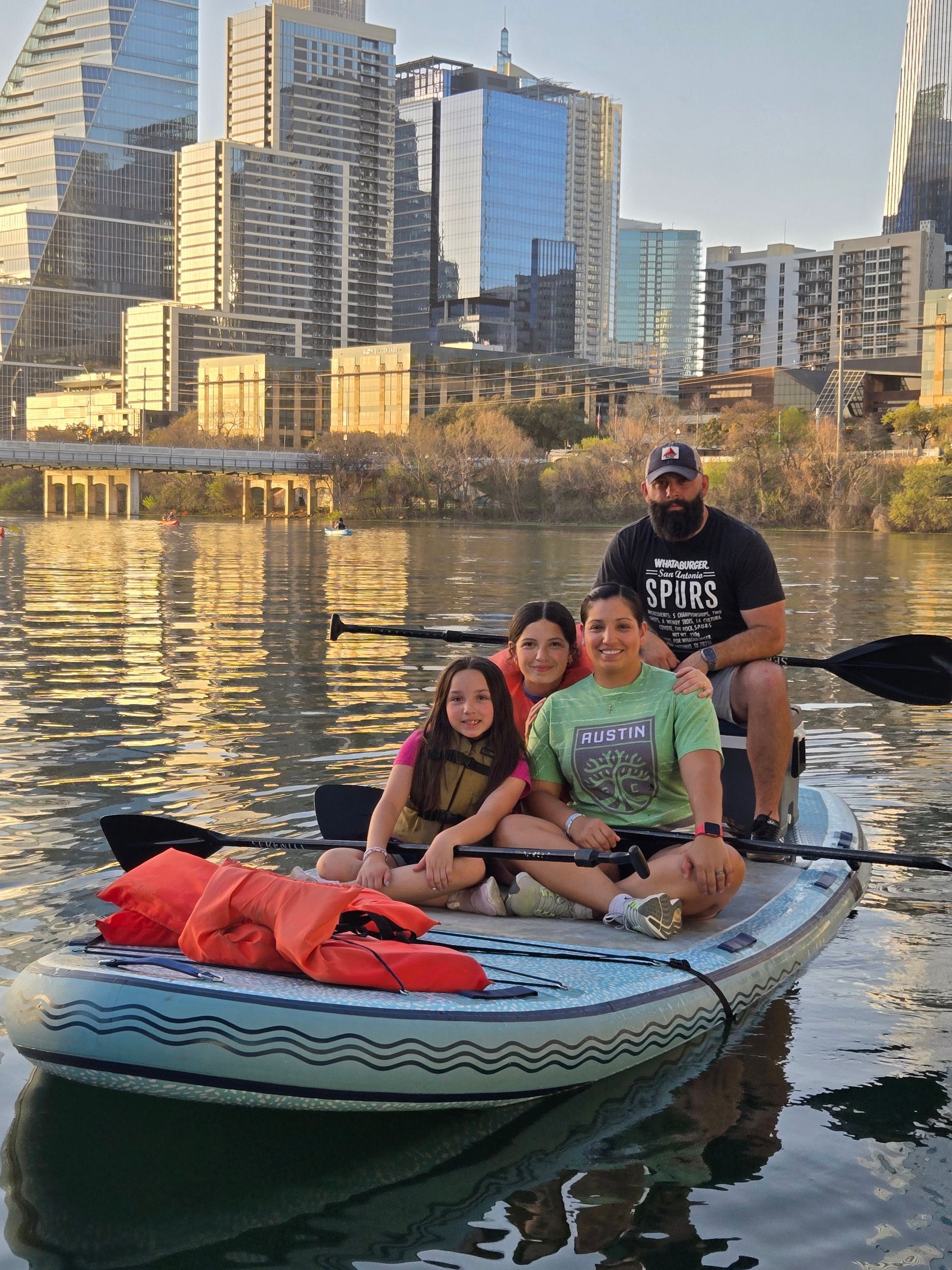 Summer paddleboard group wearing swim gear and hats on a sunny day in Austin