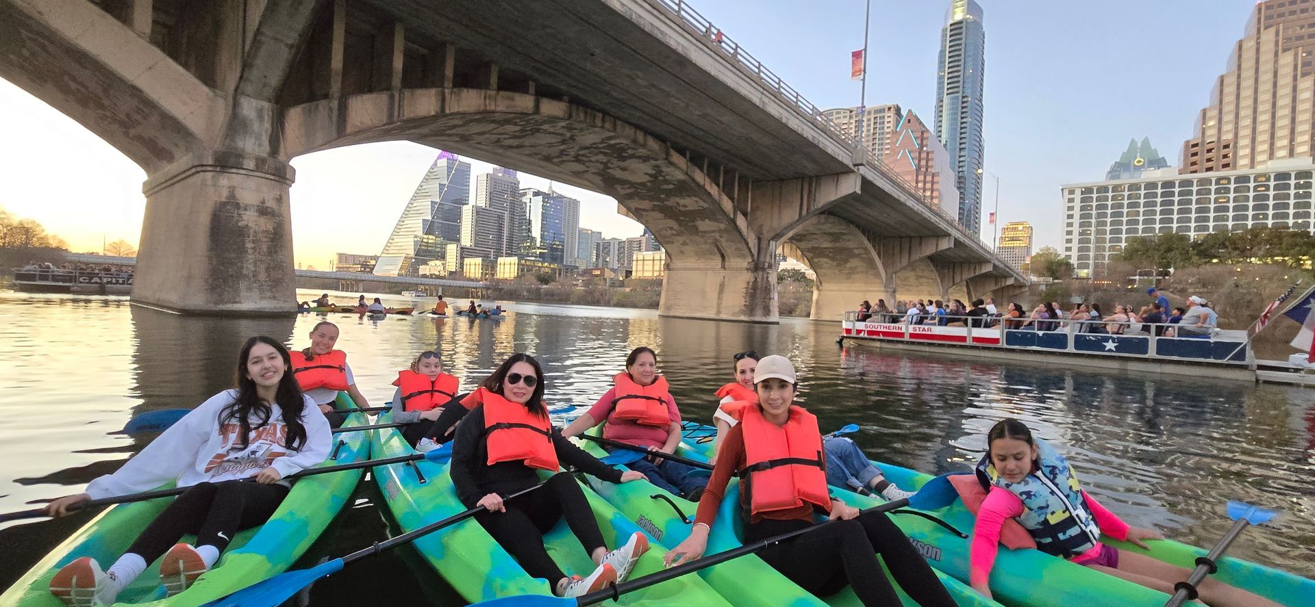 Paddleboarders wearing long sleeve shirts and leggings during fall in Austin