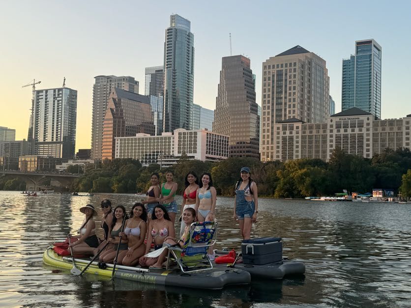 Bachelorette party paddleboarding in themed outfits on Lady Bird Lake