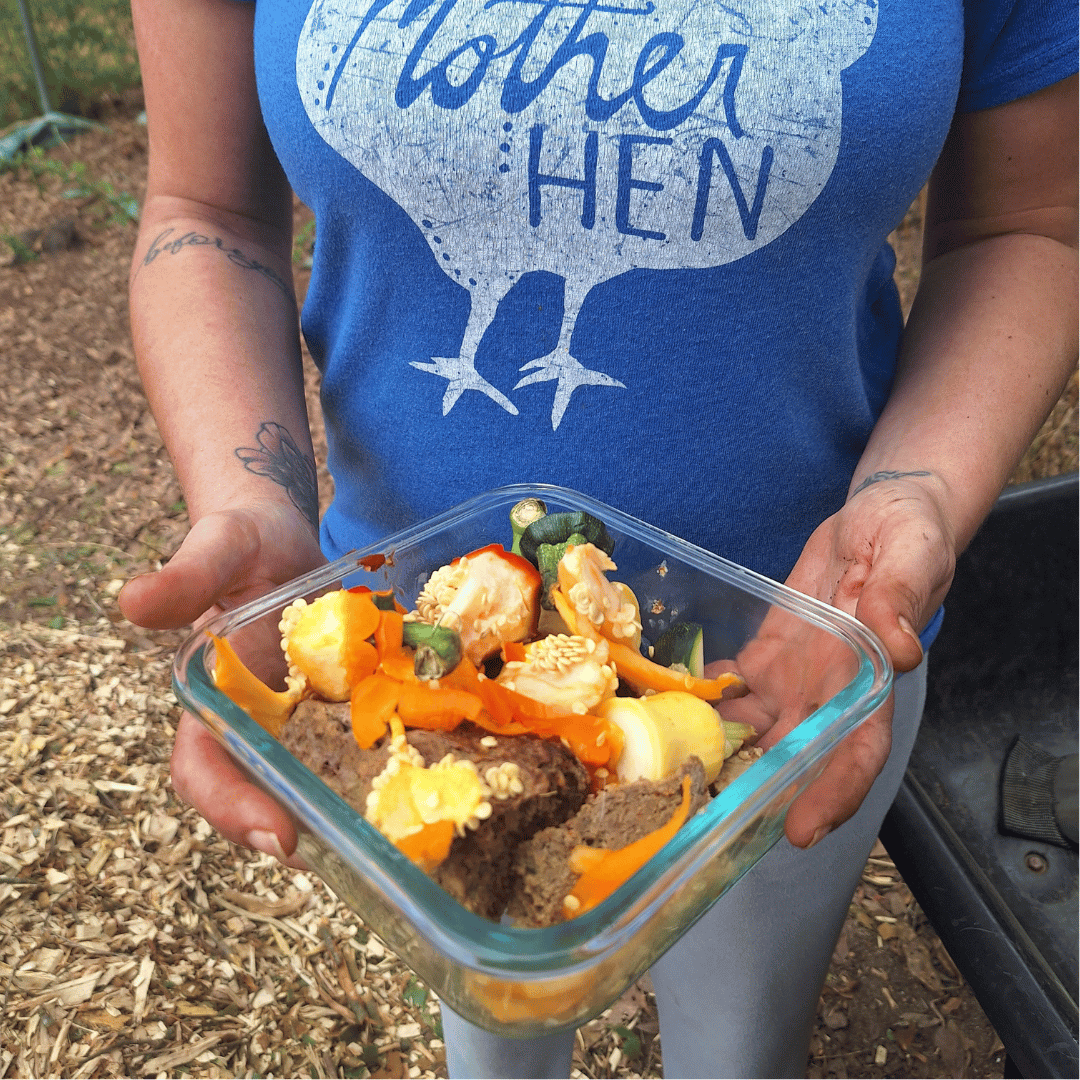 woman holding a square glass container full of food scraps