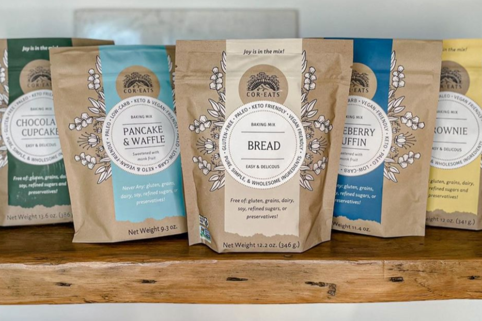 a shelf of flour mixes that have the cor eats logo