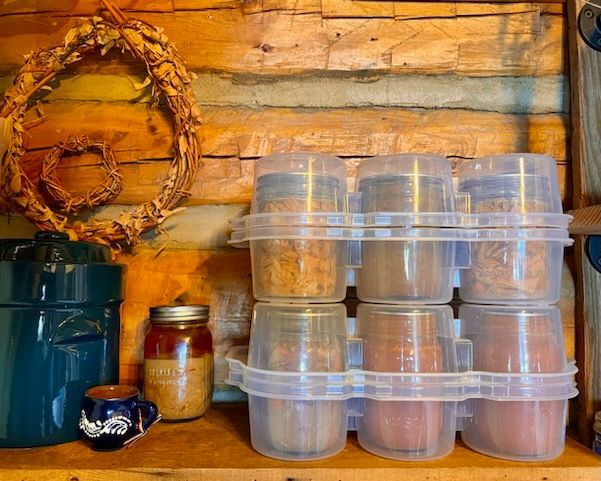 roots and harvest safe crates stacked on a shelf in a log cabin