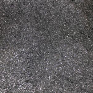 Close-up of dark gray textured surface with a rough, speckled pattern