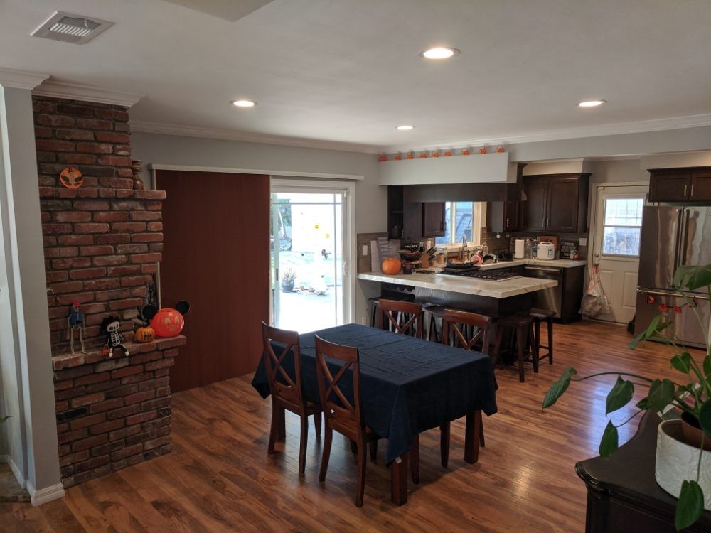 There is a table and chairs in the middle of the room.