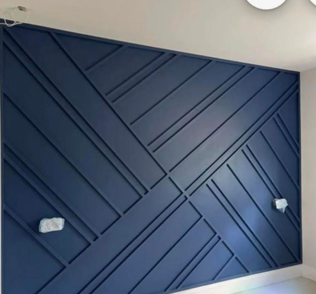 A blue wall with a geometric pattern on it