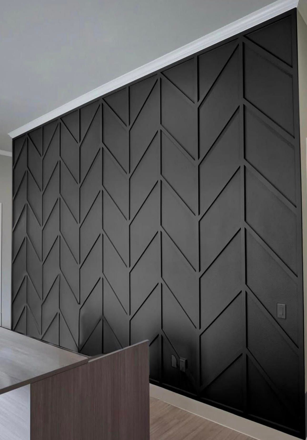 A black wall with a chevron pattern on it in a living room.