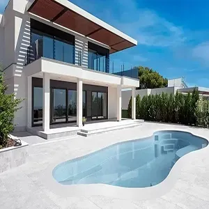 Modern two-story house with a curved backyard swimming pool under a bright blue sky