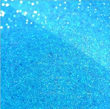 Blue glittery textured background with sparkling light bokeh