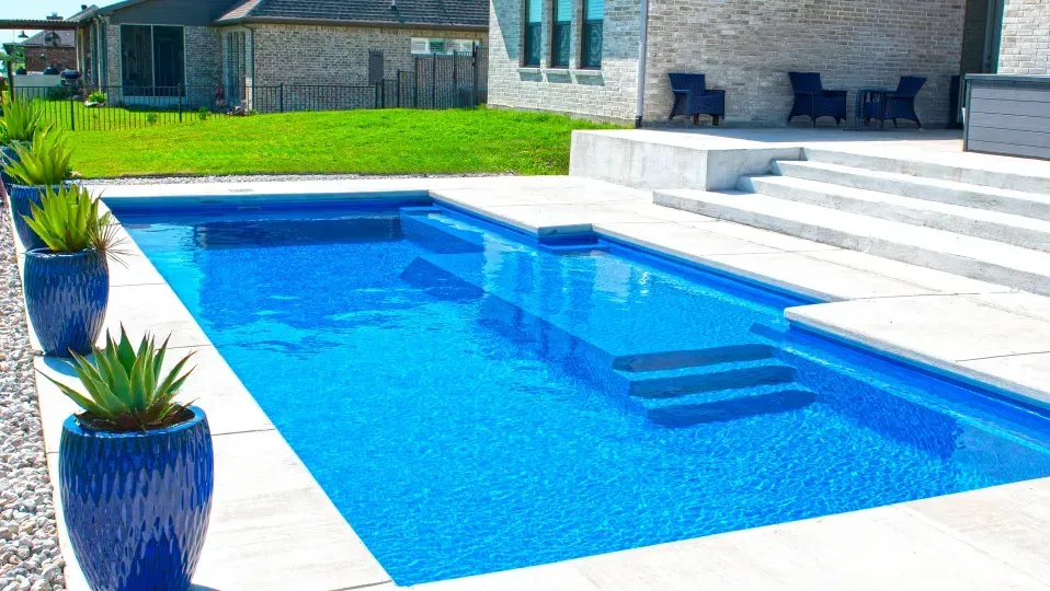 Modern luxury home with a backyard swimming pool and large glass windows
