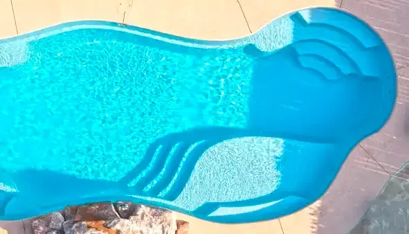 Light turquoise water surface with sunlight reflections and gentle ripples