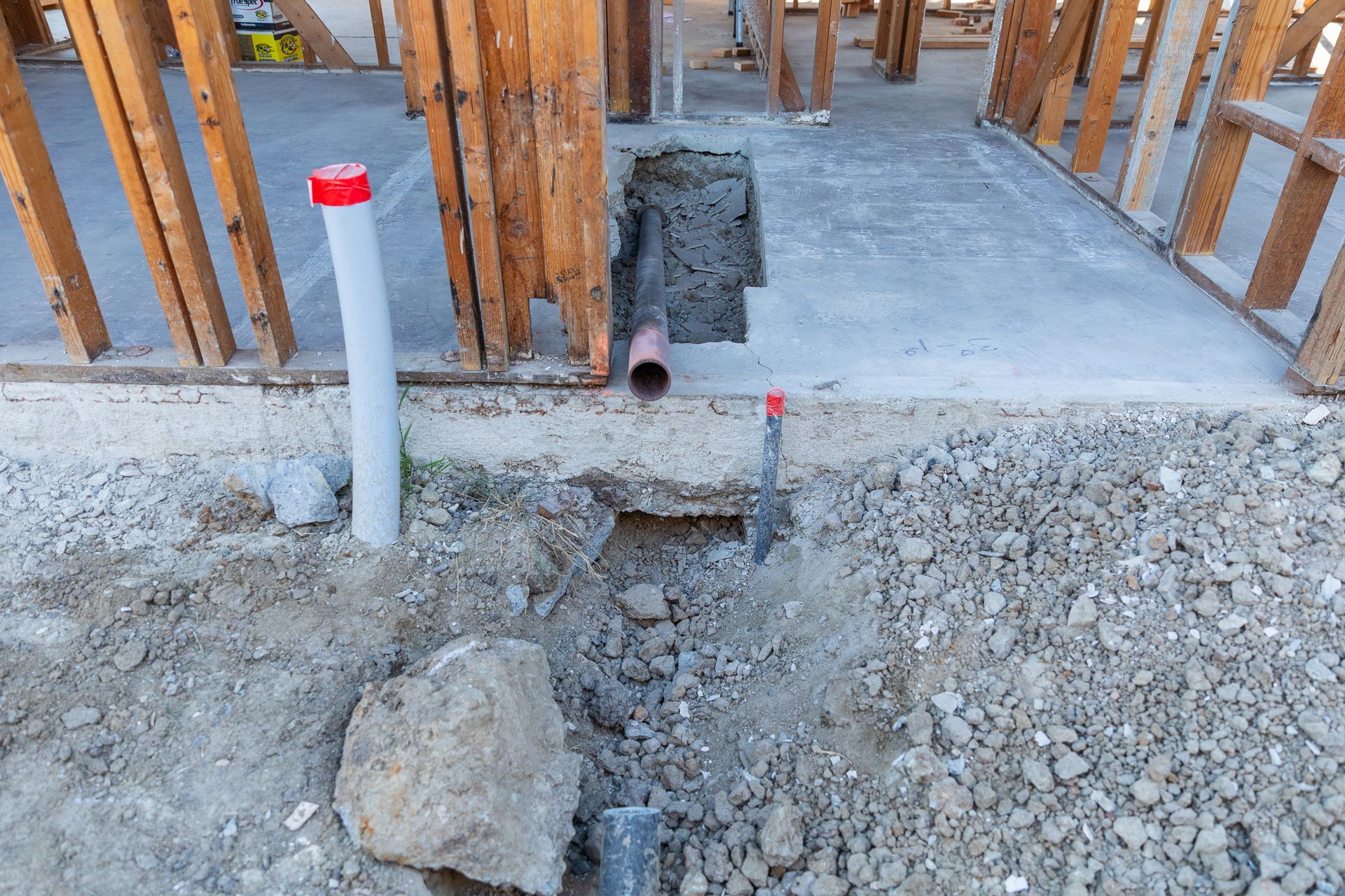 A pipe is being installed in the ground in a construction site.