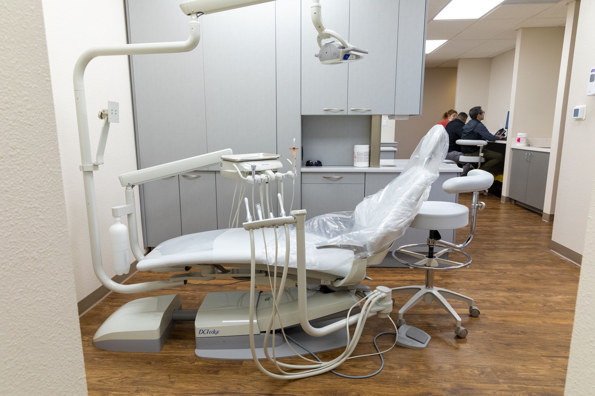 A dental chair is sitting in a dental office.