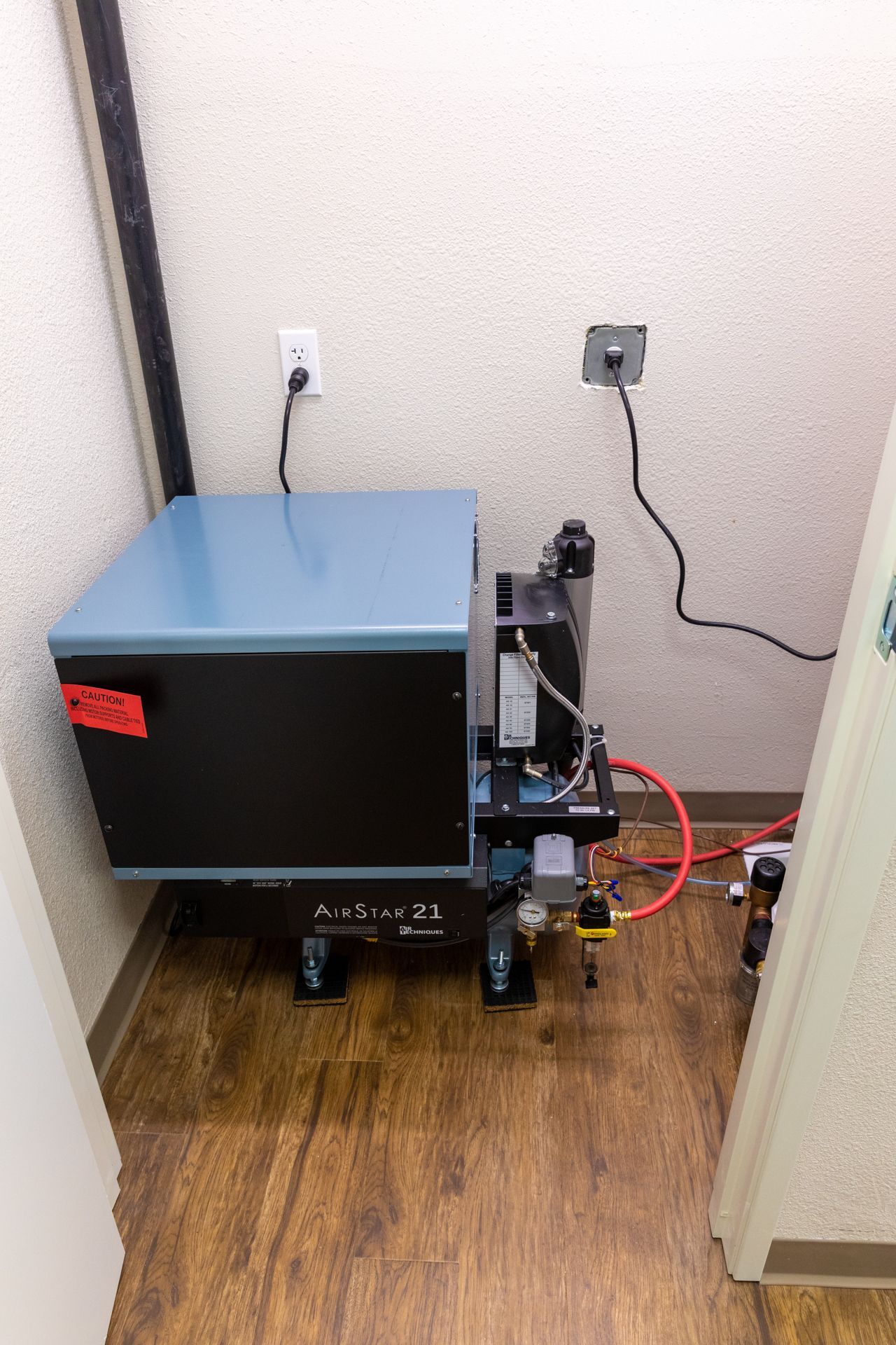 A machine is sitting in a room next to a door.