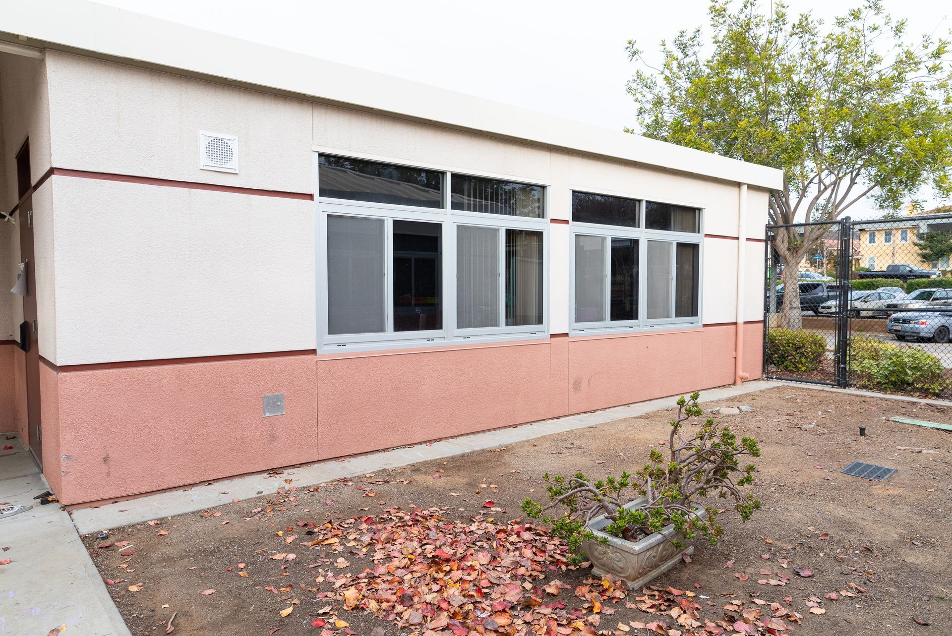 A white and pink building with a lot of windows