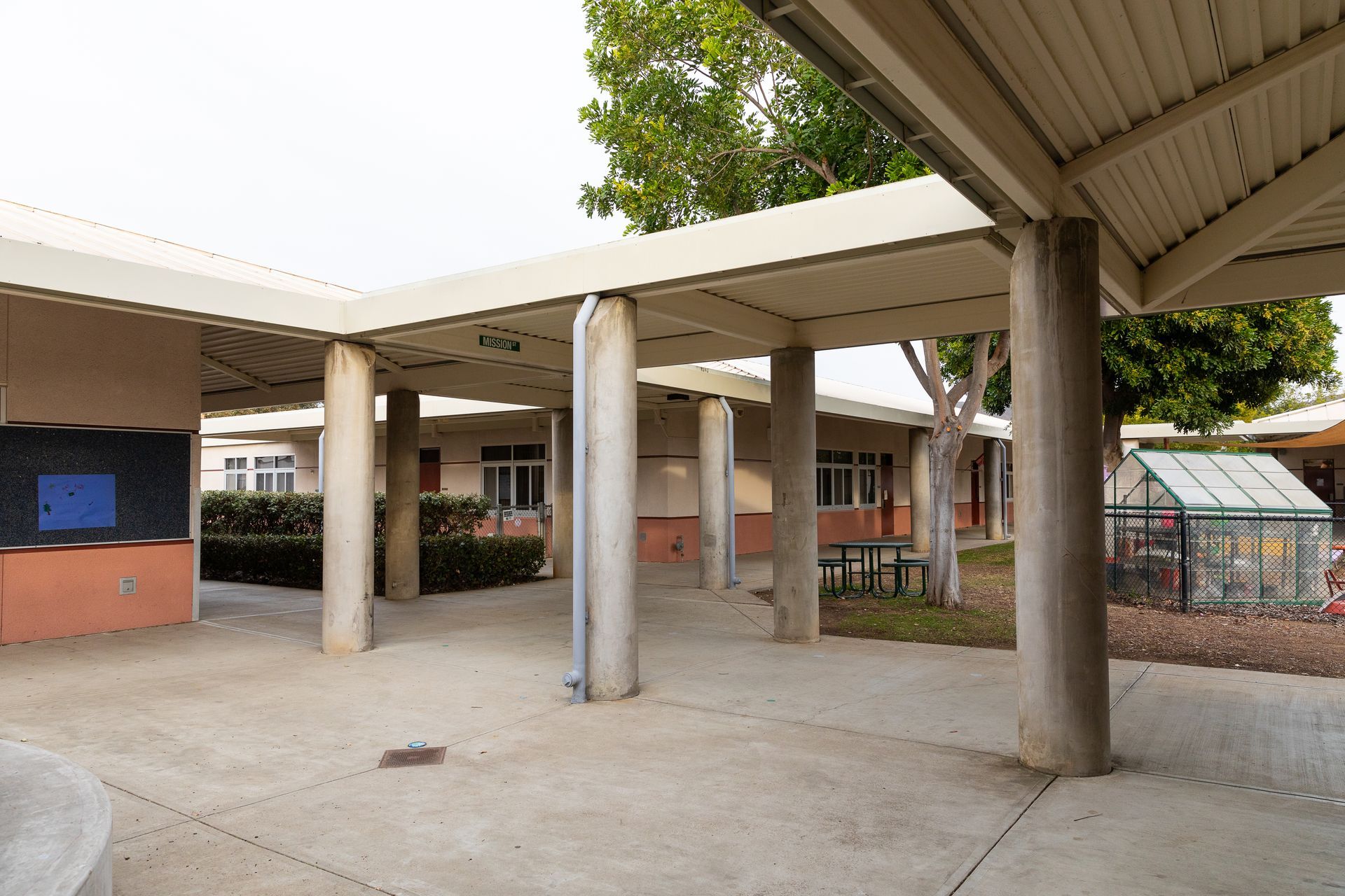 An empty courtyard with columns and a covered walkway