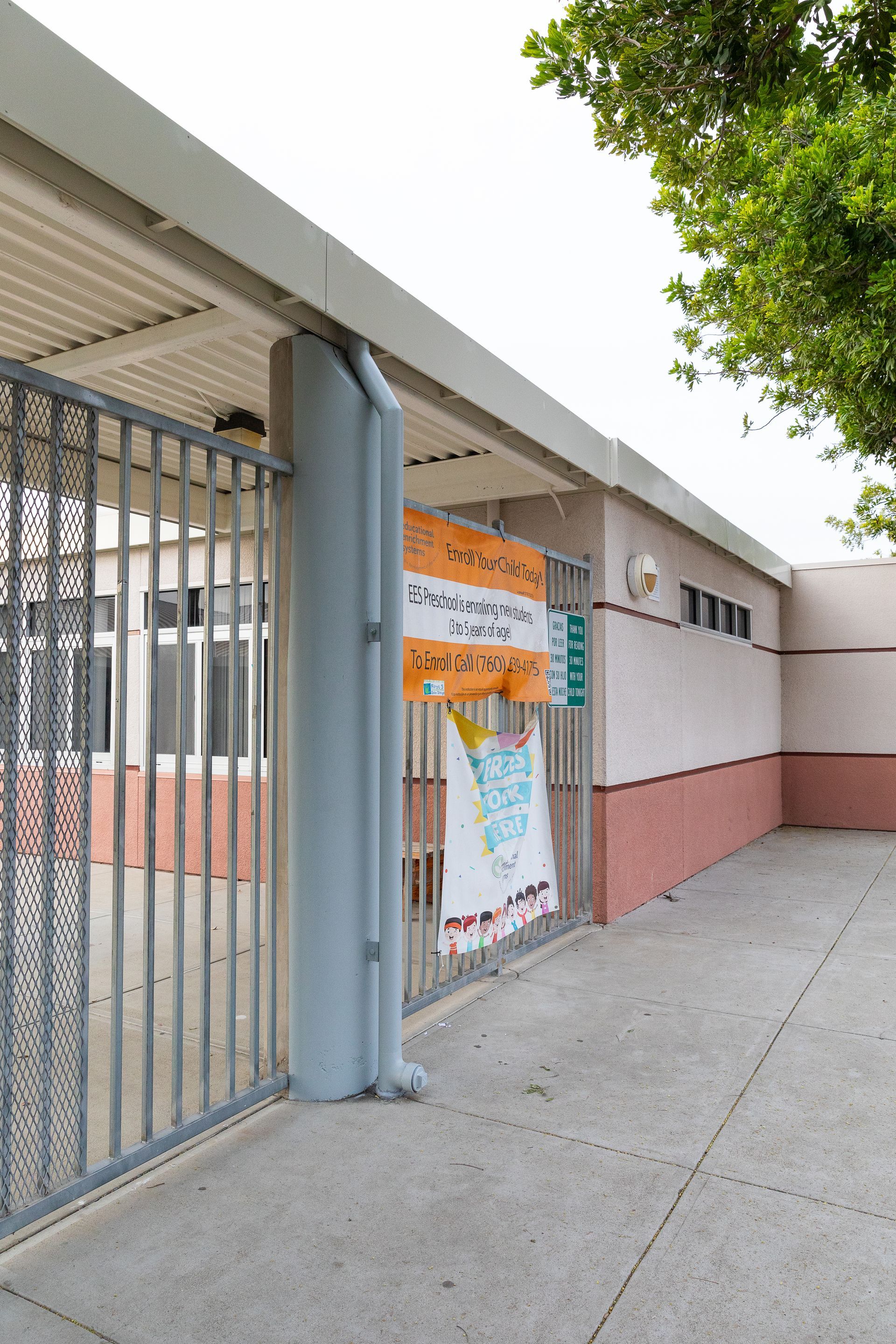 A building with a fence and a sign that says welcome