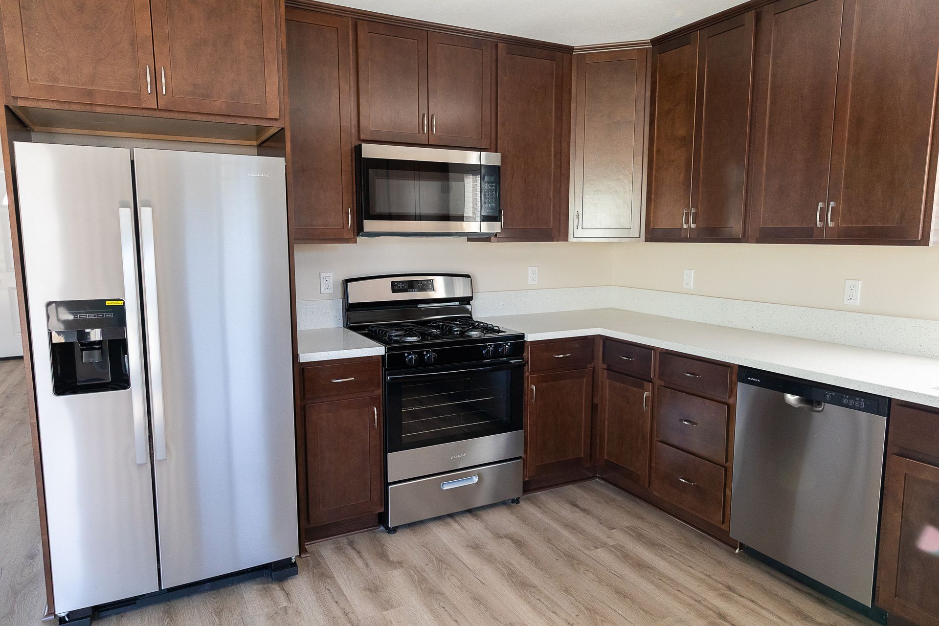 A kitchen with stainless steel appliances and wooden cabinets