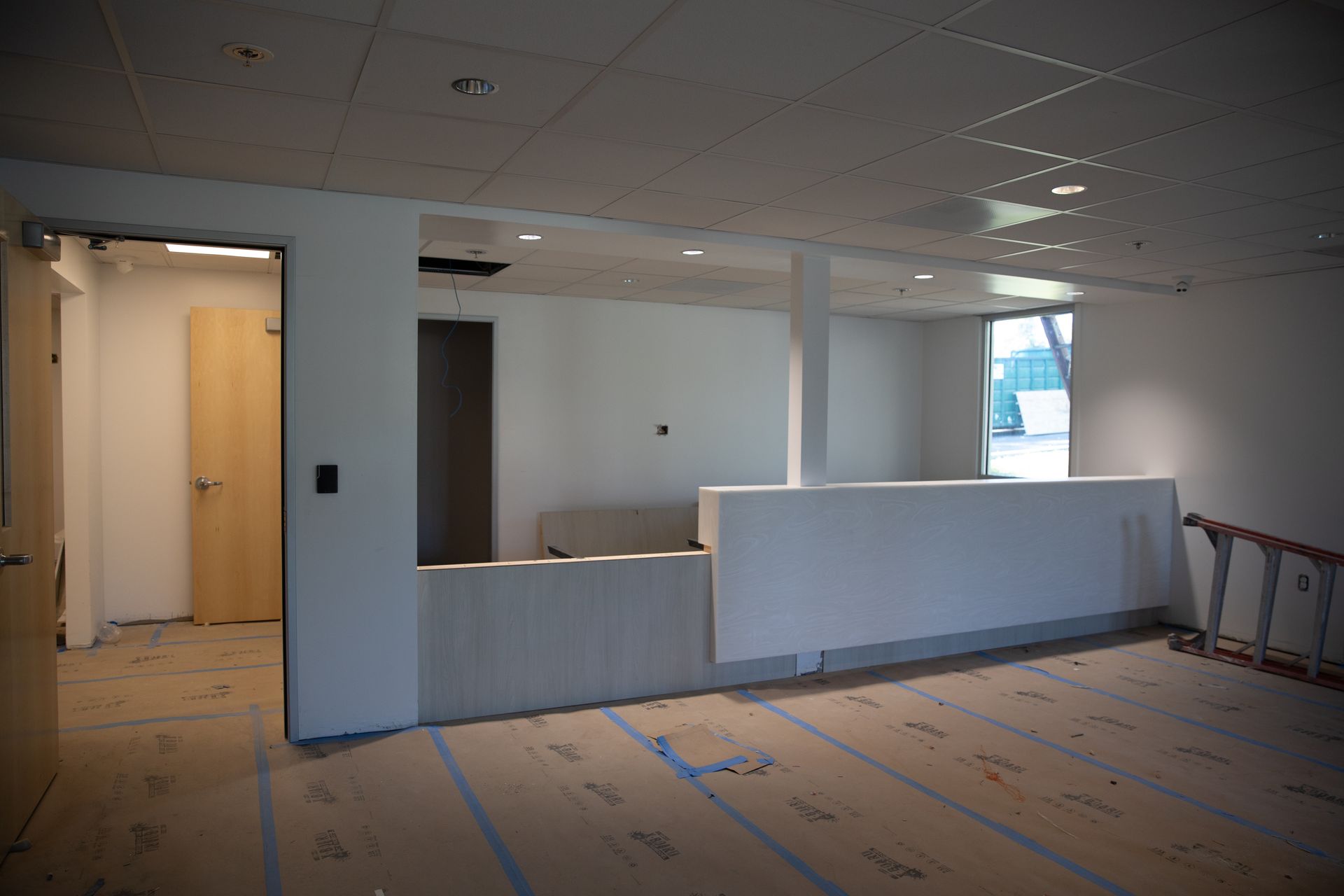 An empty room with a ladder on the floor