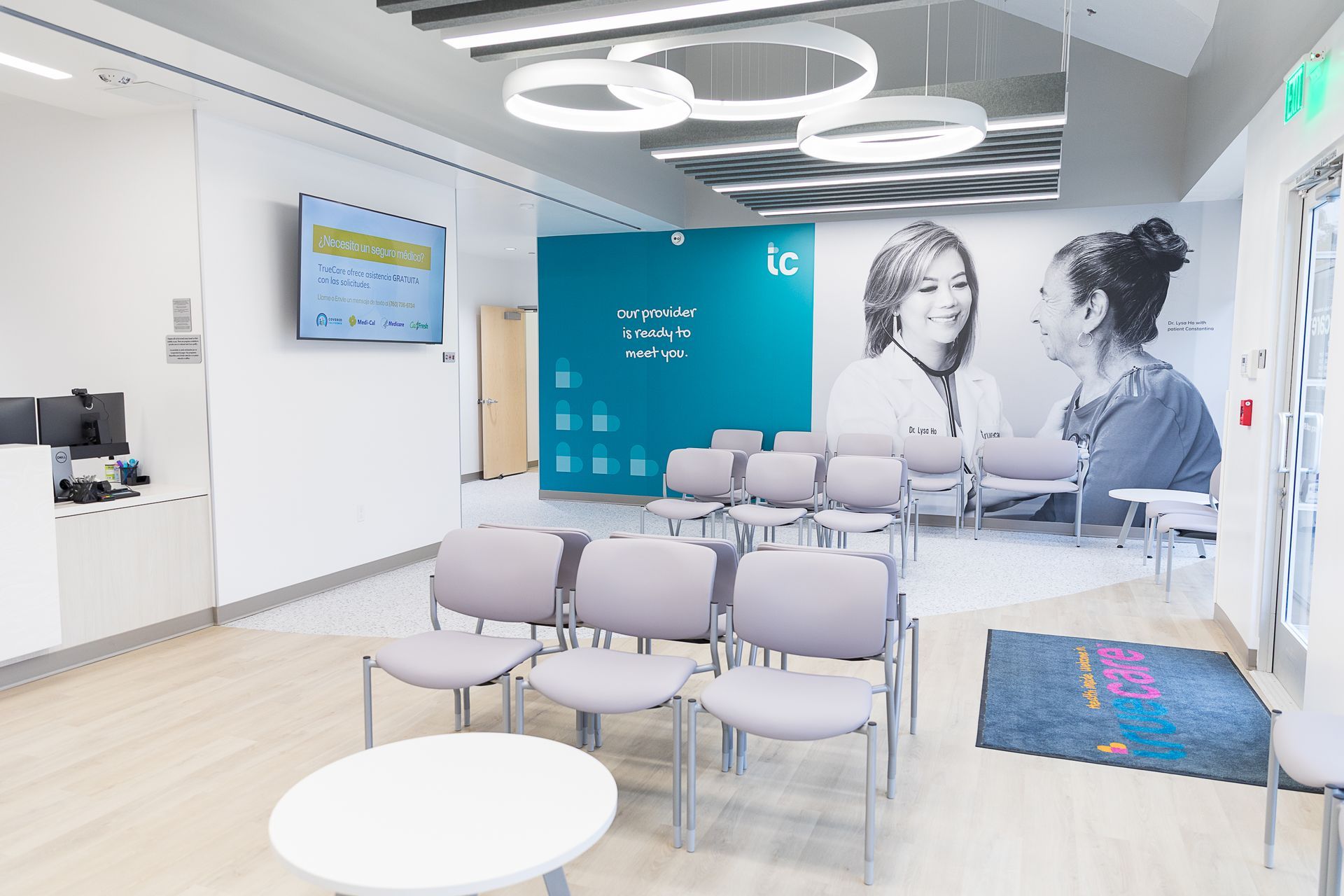 A waiting room with a picture of two women on the wall.