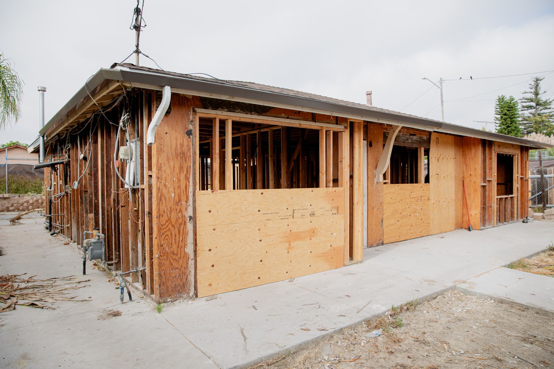 Partially built house with wood framing and brick walls at a construction site