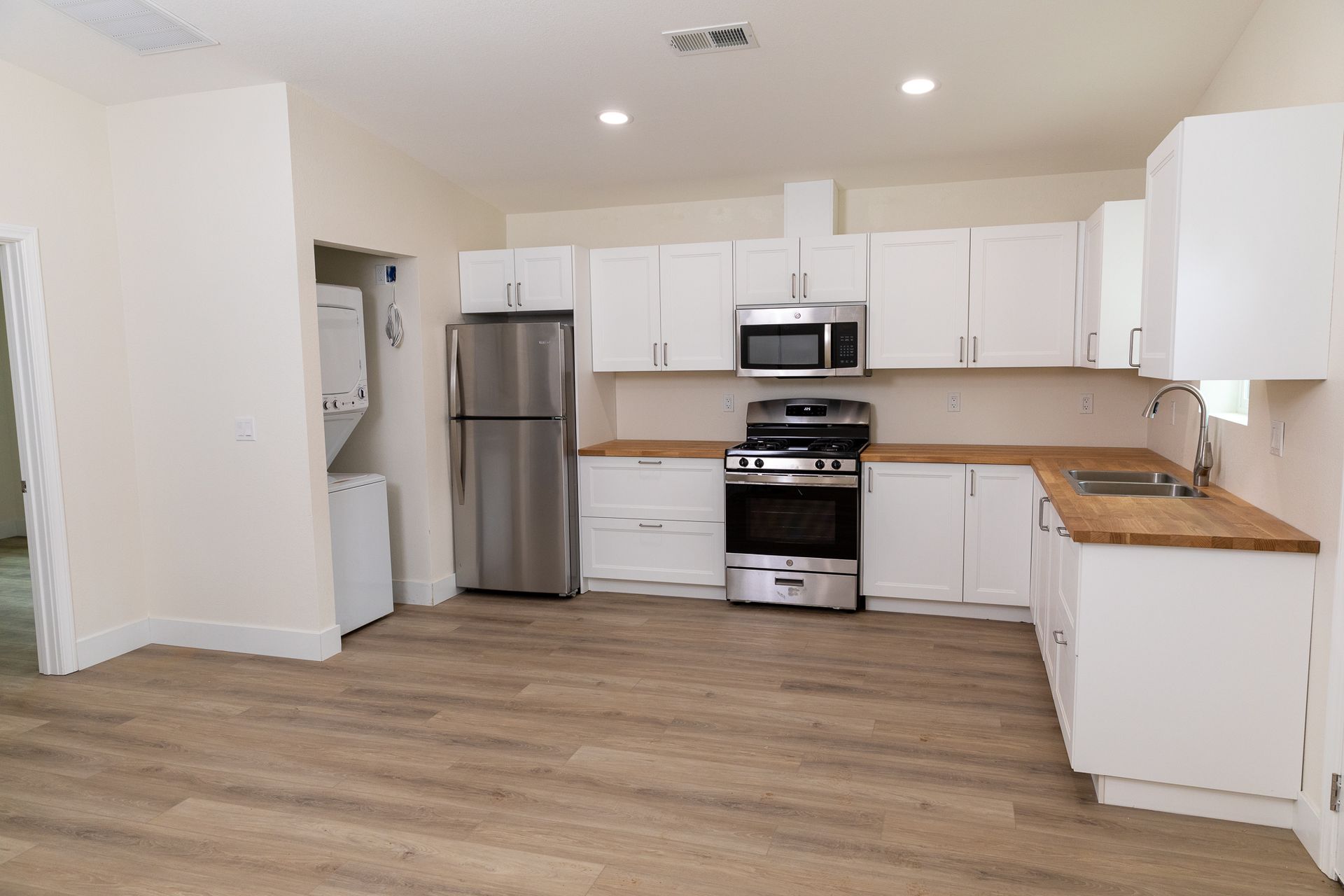 A kitchen with stainless steel appliances and white cabinets