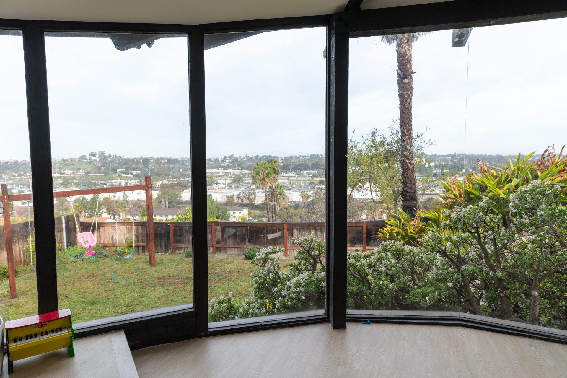 A room with a lot of windows and a view of a city