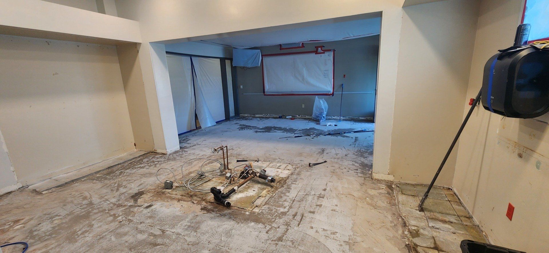 An empty room with a broom on the floor