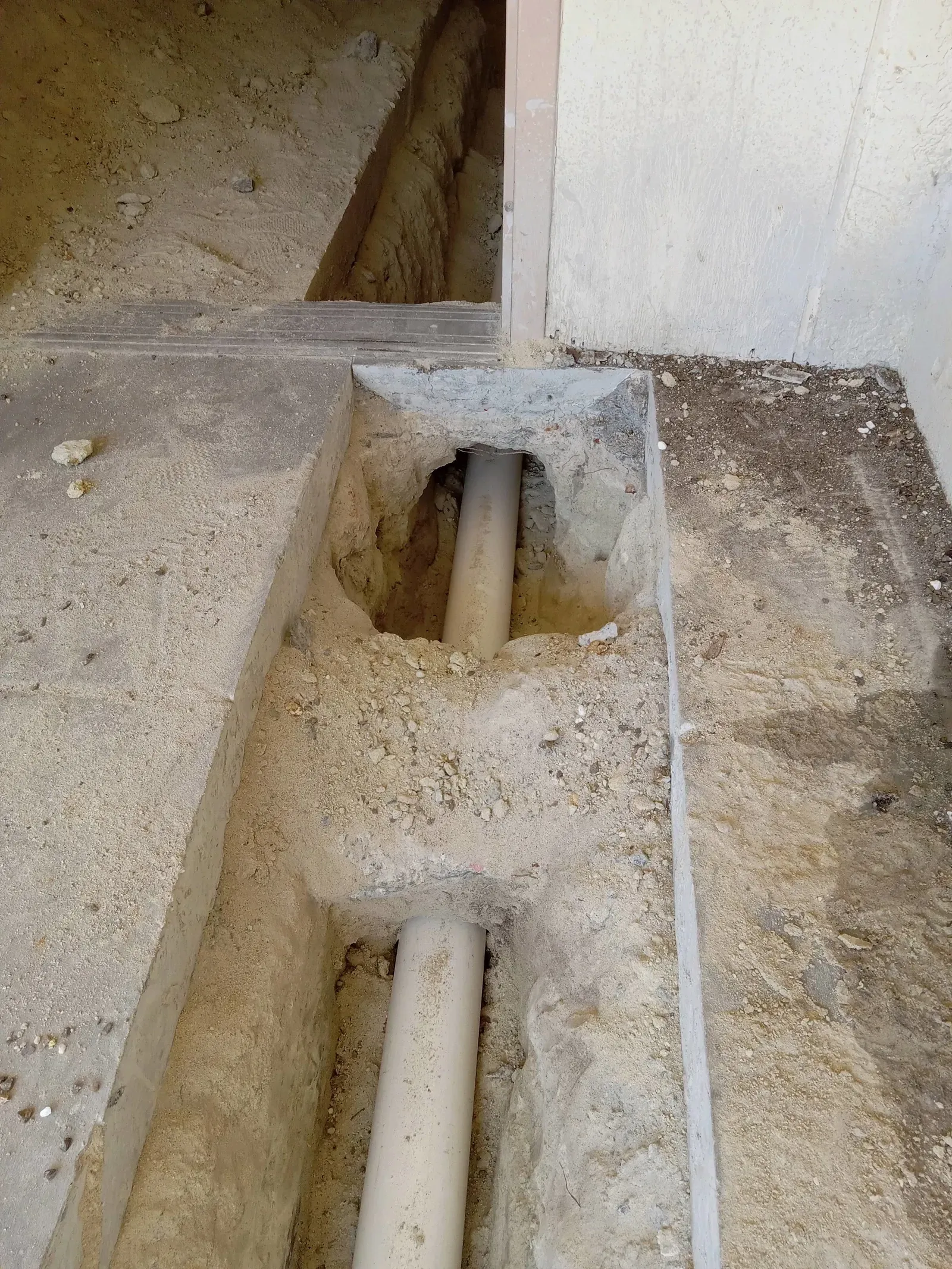 A pipe is coming out of a hole in the ground.