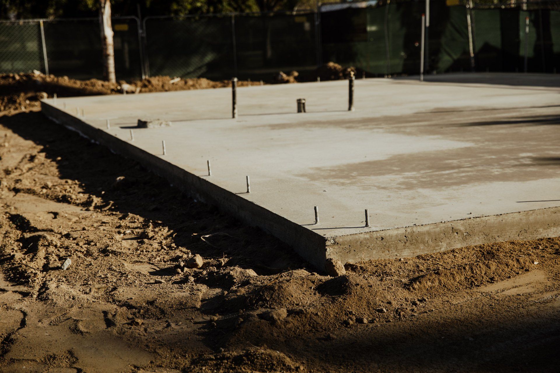 A concrete slab is being built on a construction site