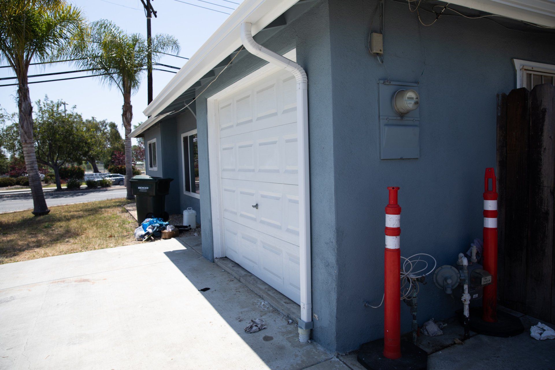 A blue house with a white garage door