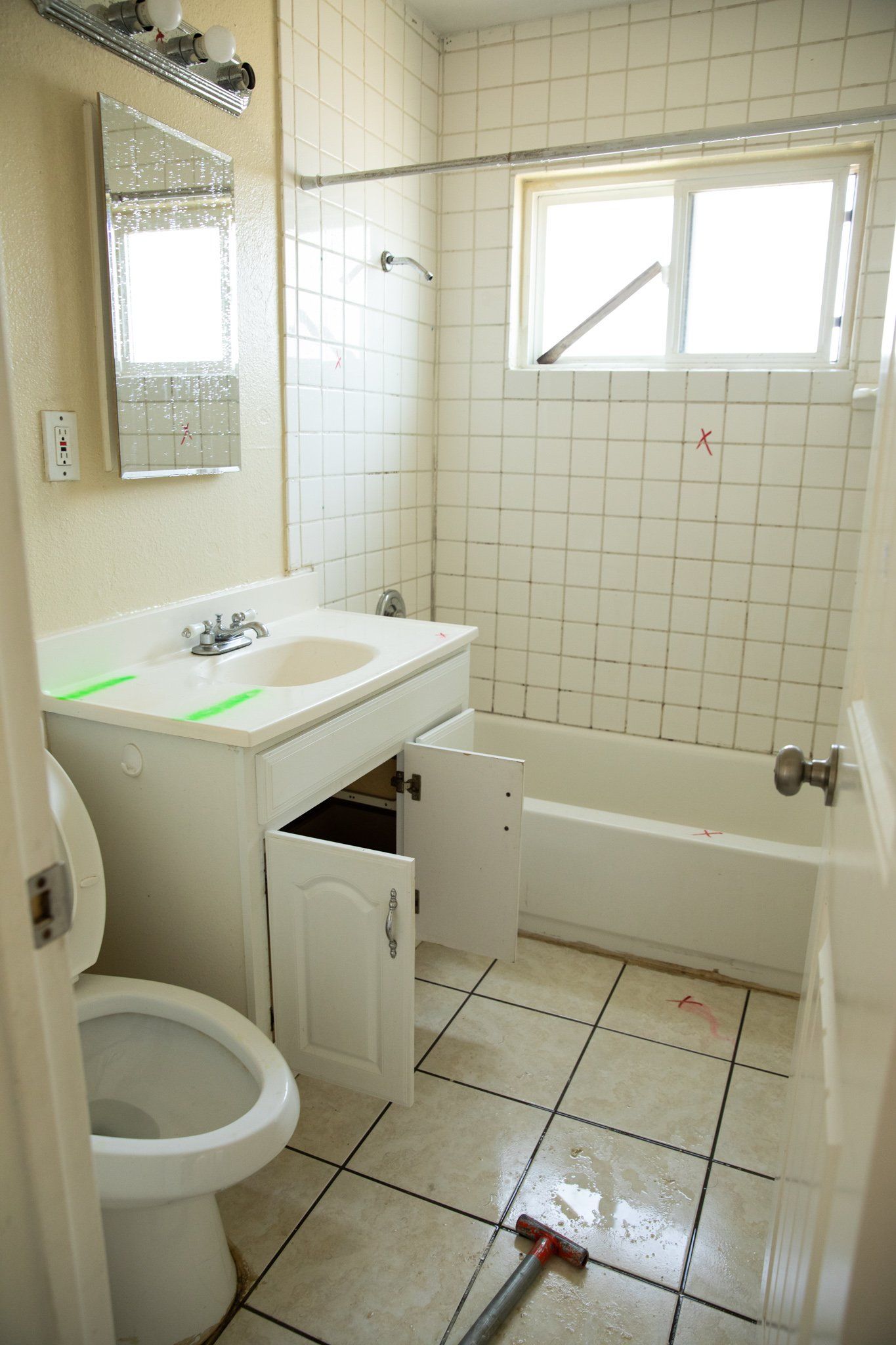 A bathroom with a toilet a sink and a bathtub