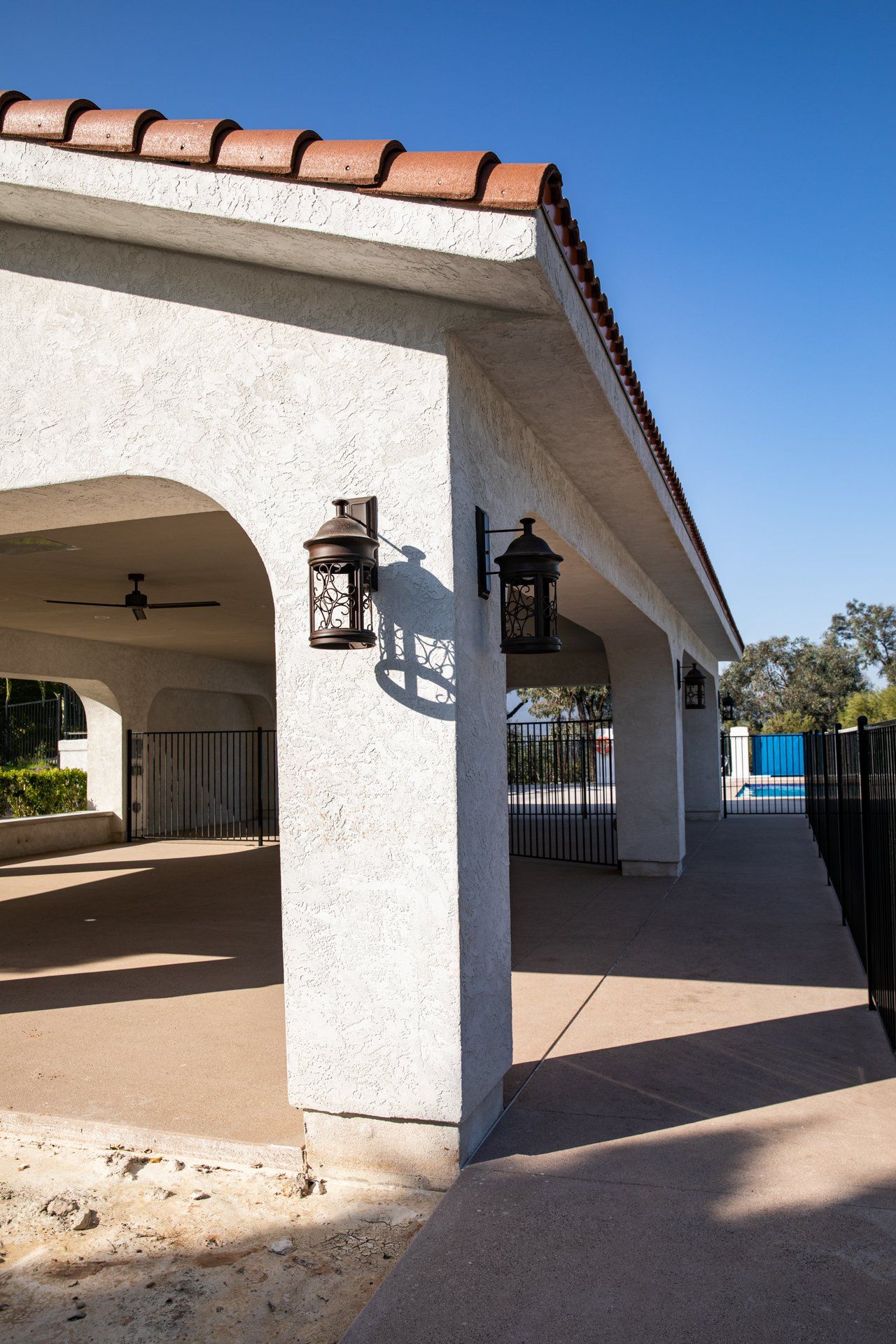 A white building with a tiled roof and a lantern on the side of it.