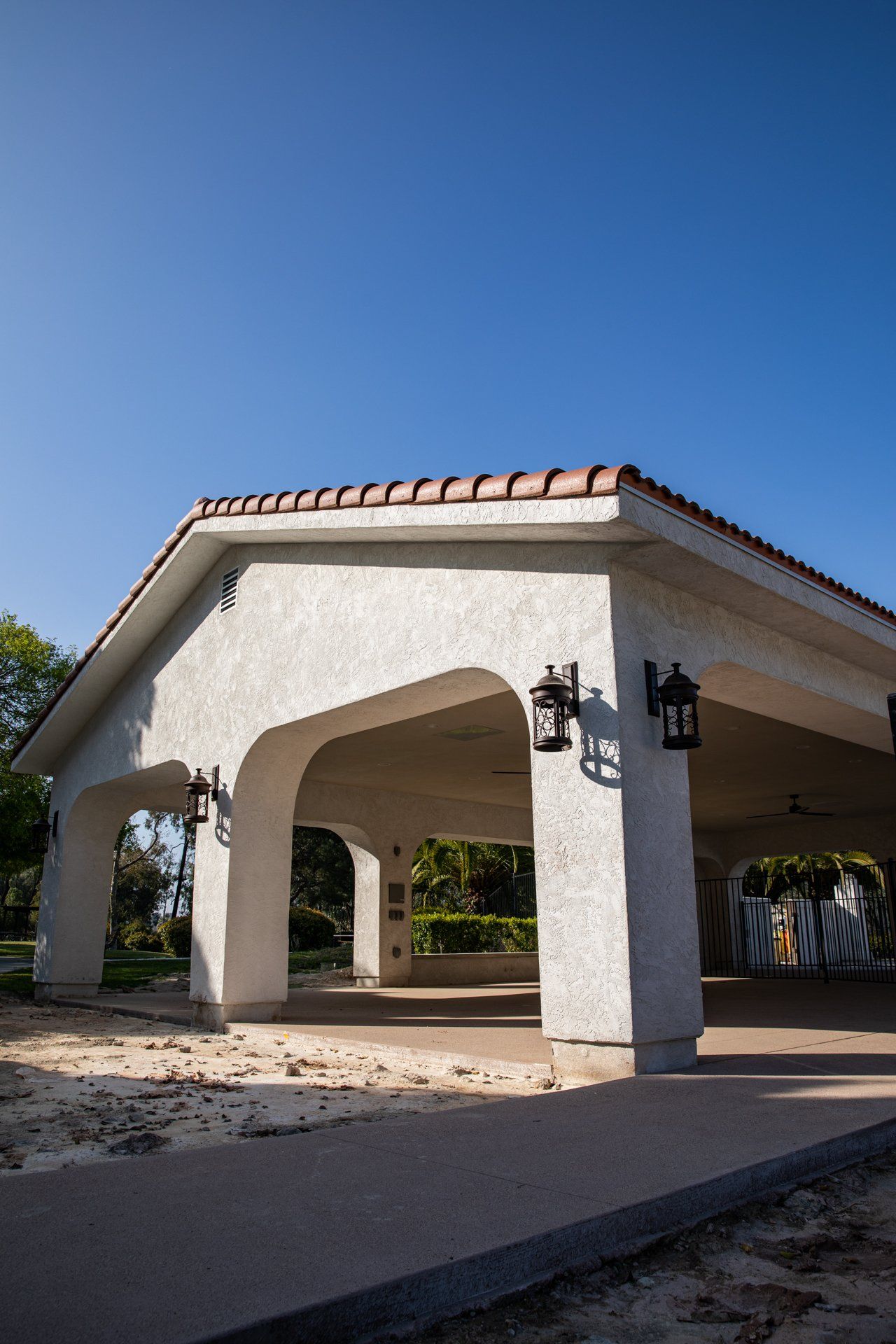A white building with arches and a tiled roof