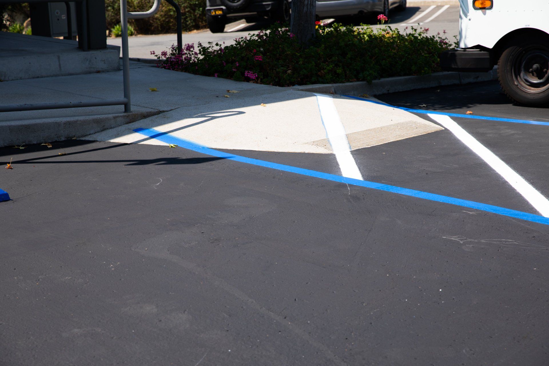 A white van is parked in a handicapped parking spot