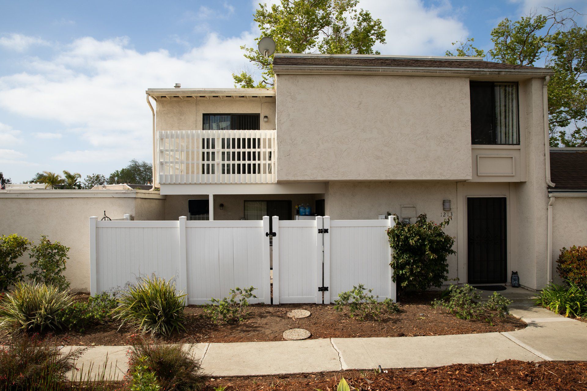 A house with a white fence in front of it