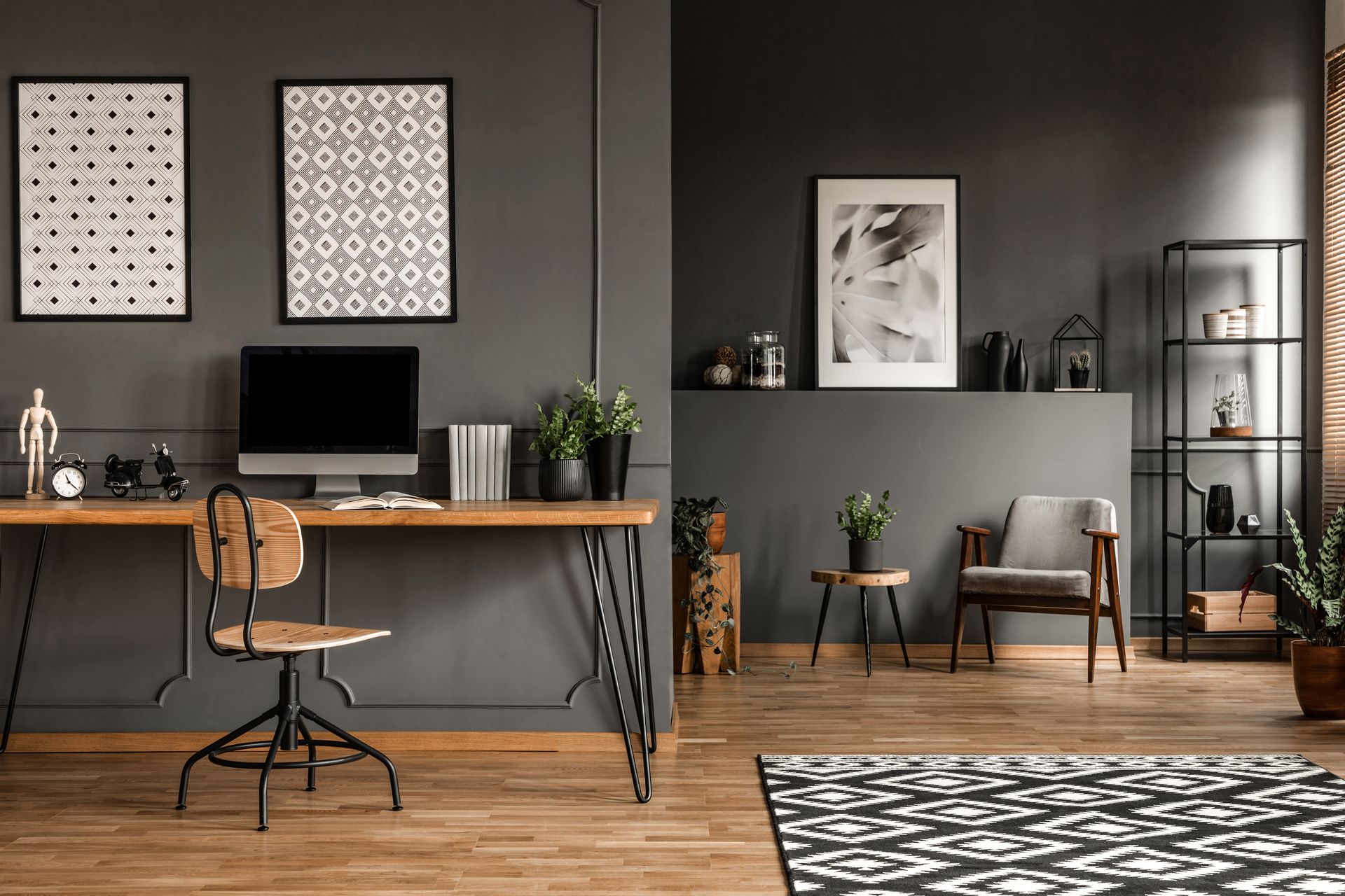 There is a desk with a computer on it in the middle of the room.