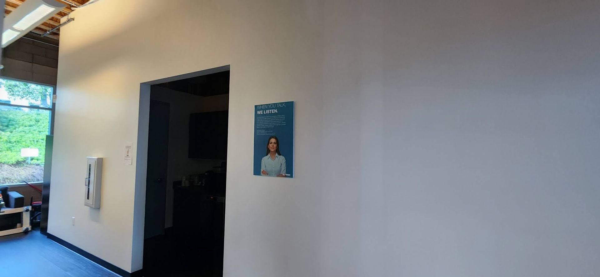 A white wall with a picture of a woman on it