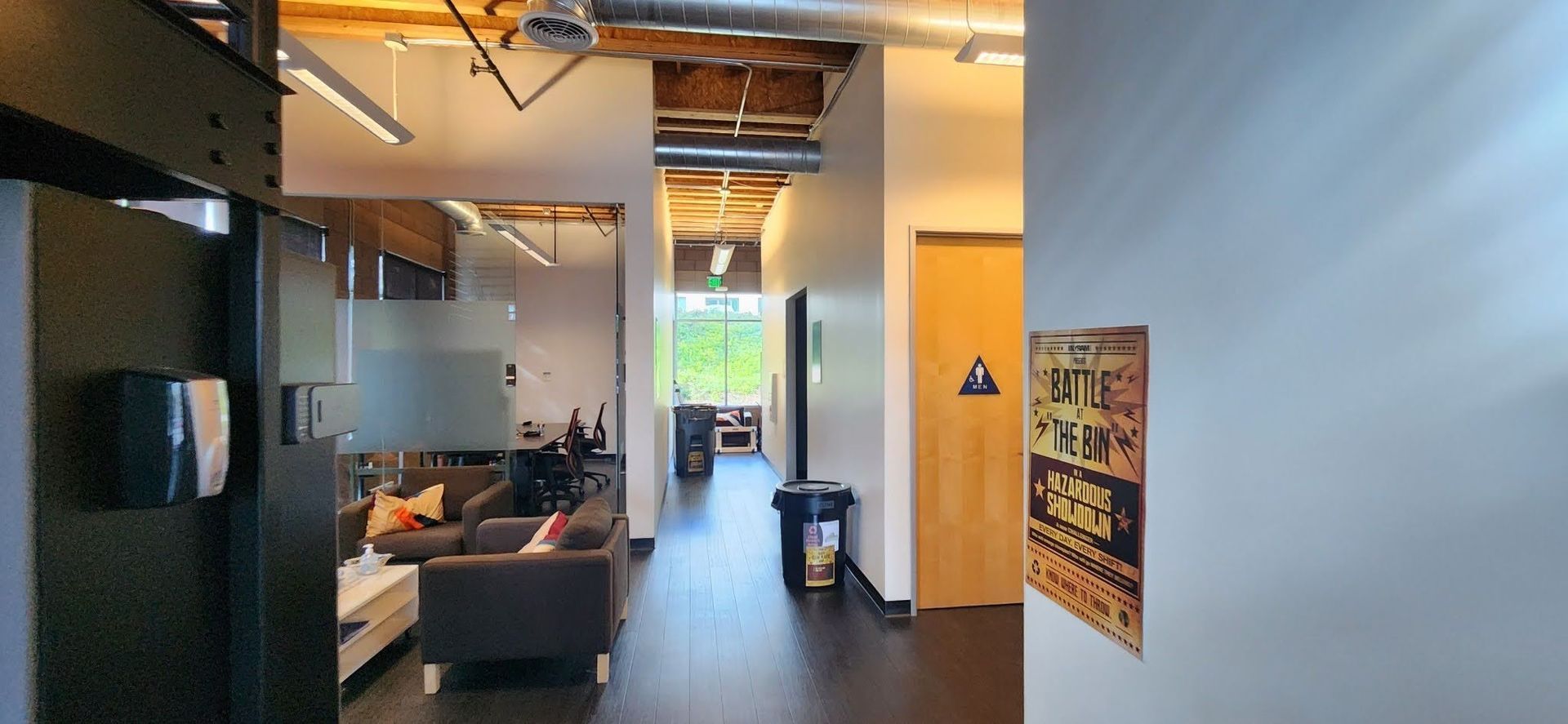 A hallway in a building with a sign on the wall that says 