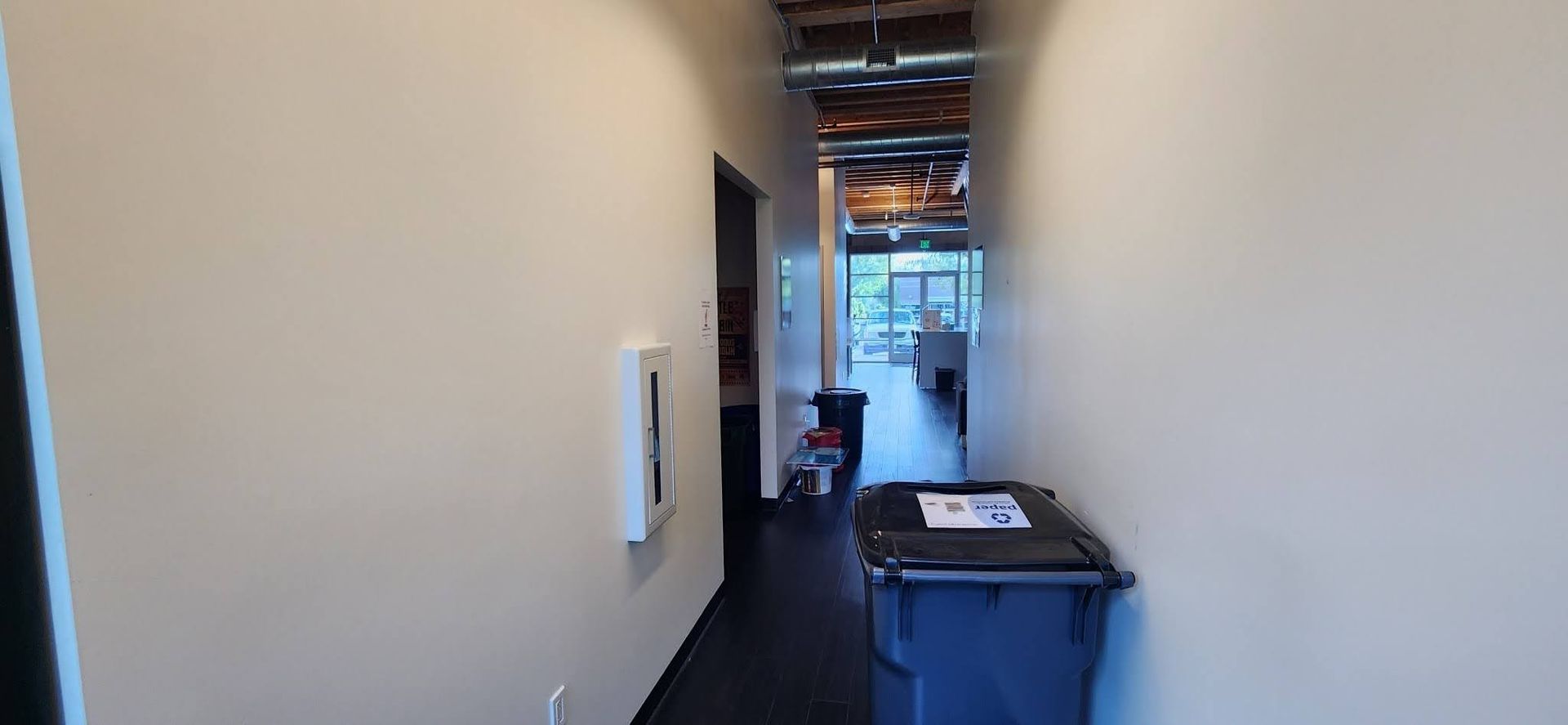 A long hallway with a trash can in the middle