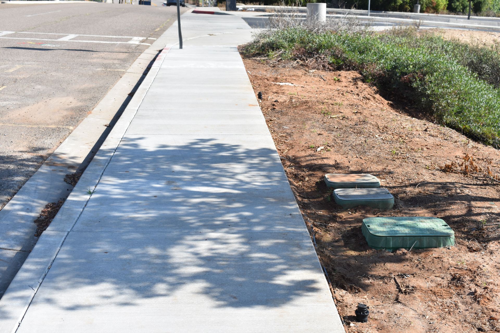A sidewalk is being built on the side of a road