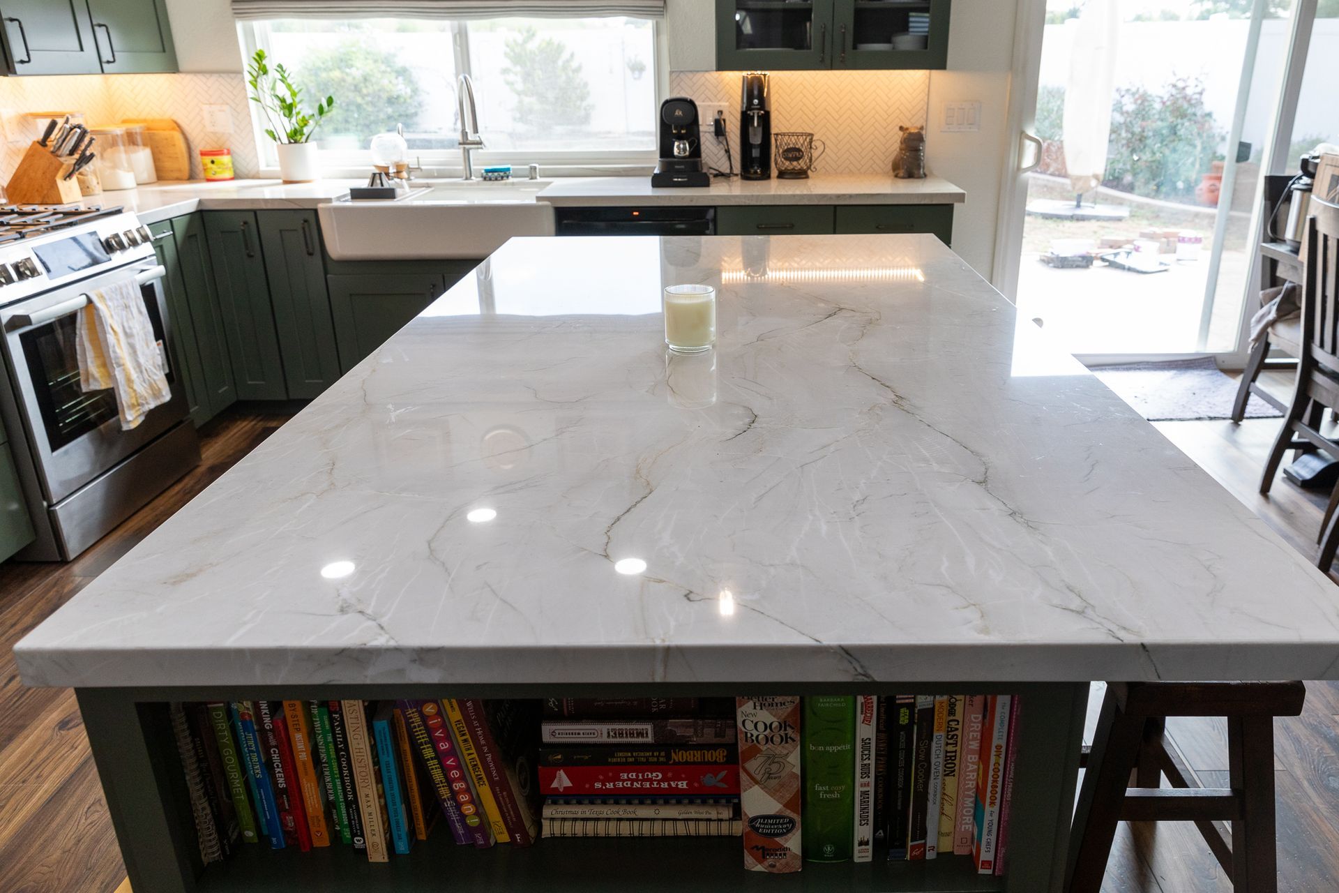 A kitchen with a large island with books on it