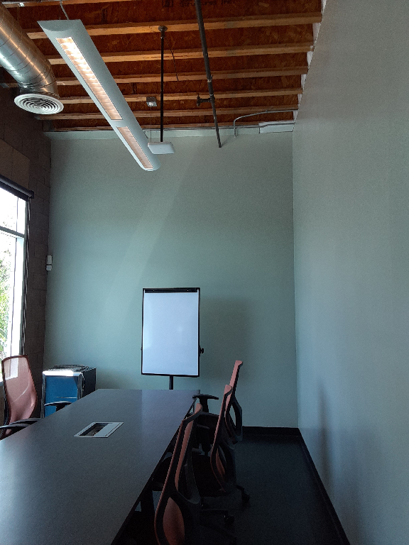 A conference room with a long table and chairs