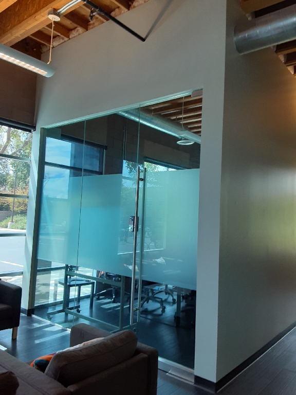 A room with a glass wall and a couch