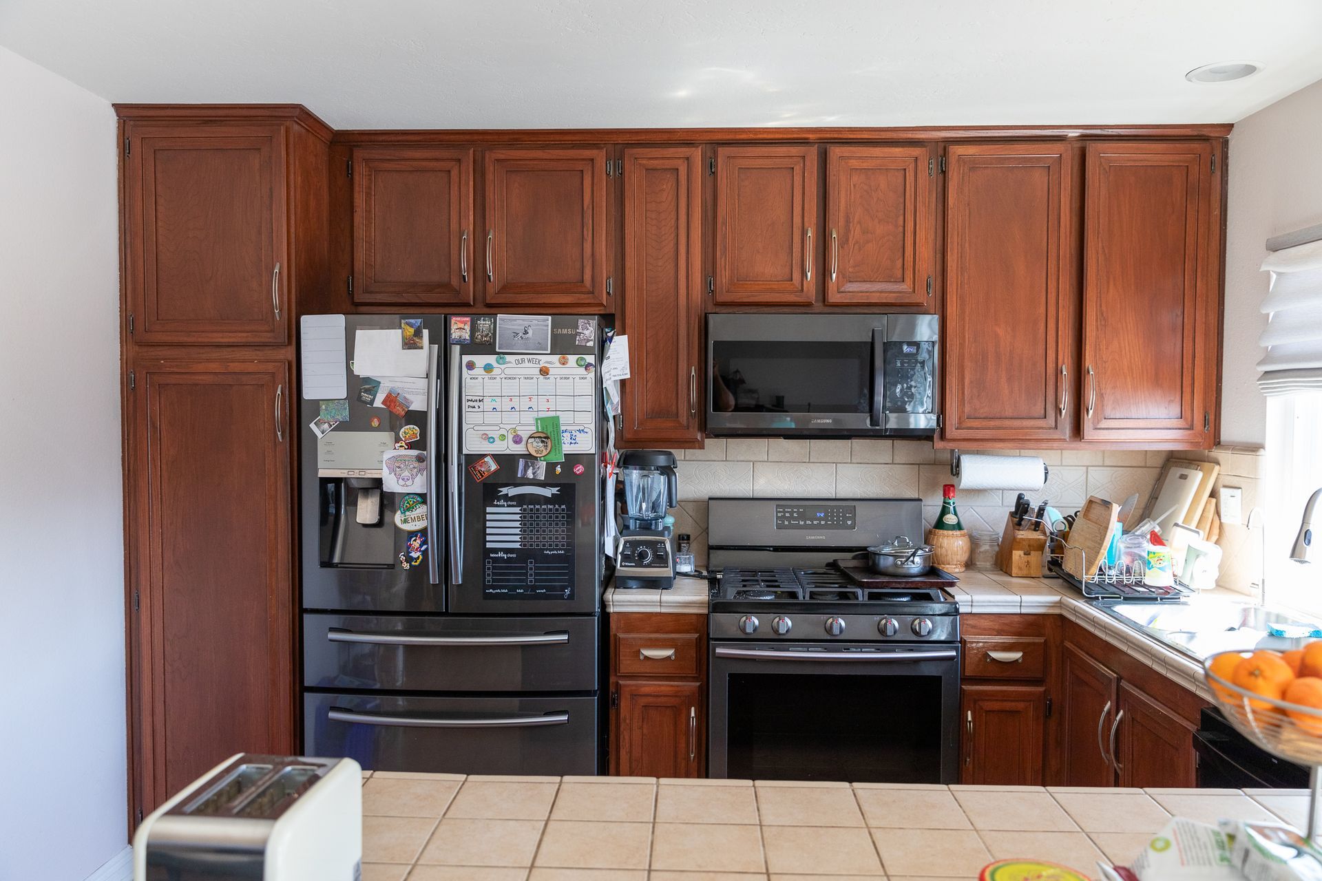 A kitchen with stainless steel appliances and wooden cabinets