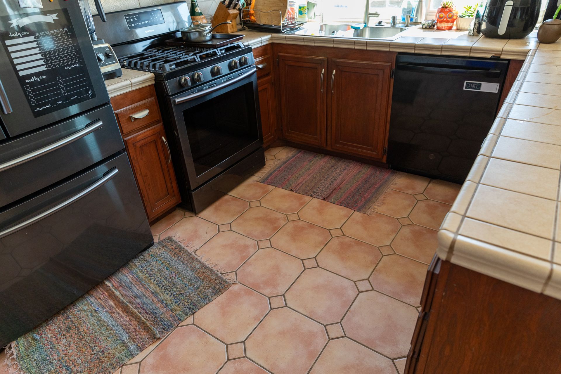 A kitchen with stainless steel appliances and wooden cabinets