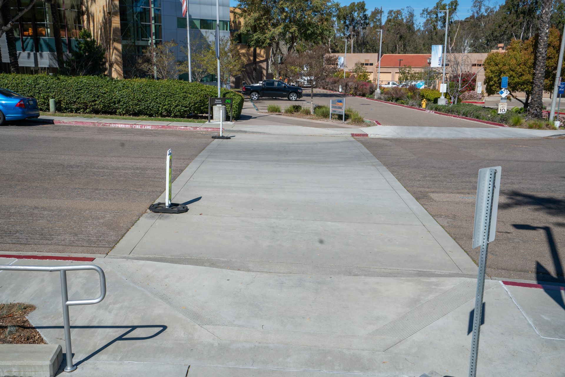 A concrete walkway with a sign that says no parking
