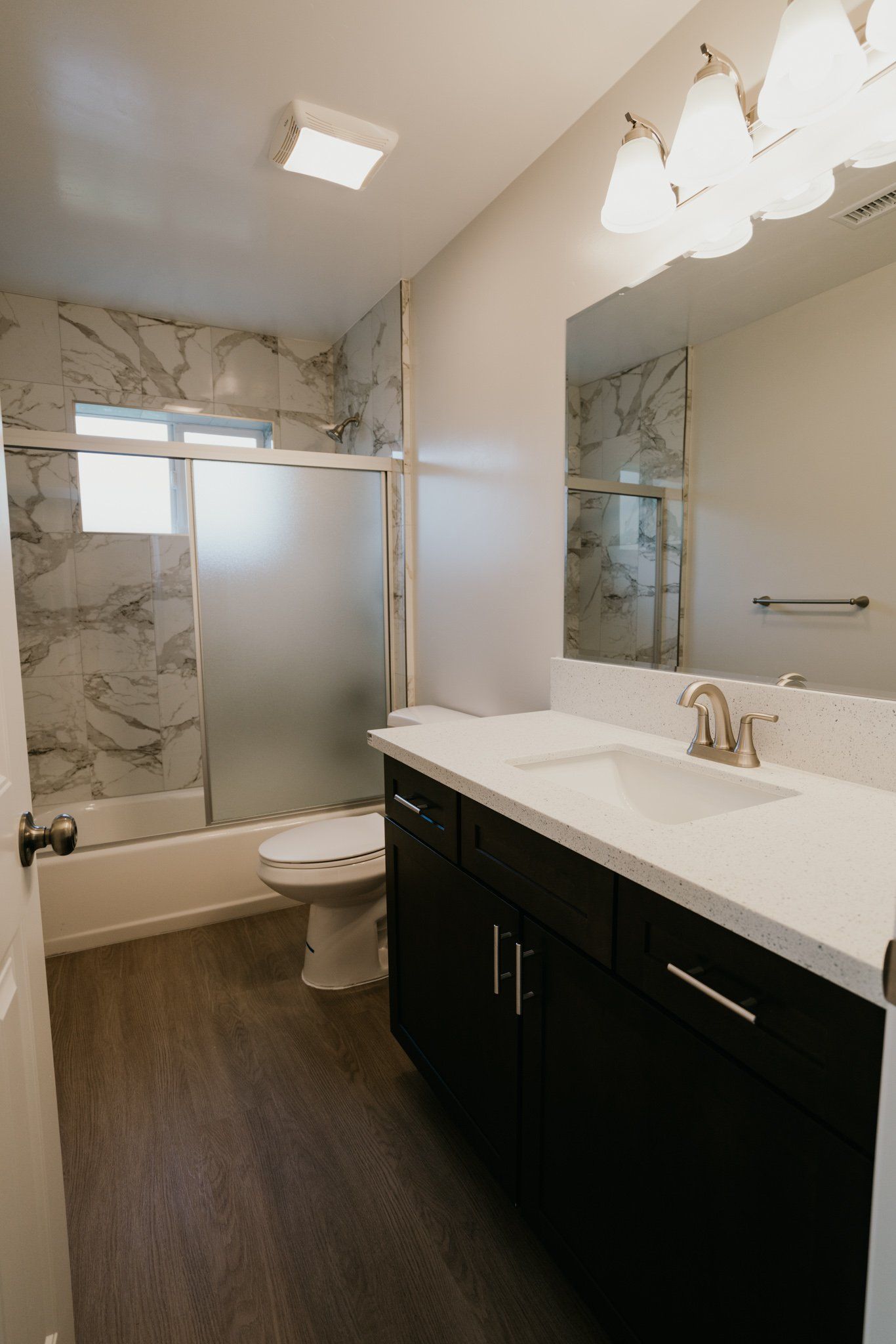 A bathroom with a toilet , sink , and shower.